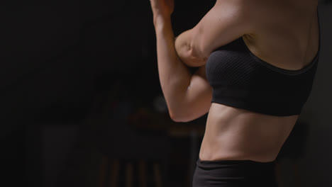 Close-Up-Studio-Shot-Showing-Mature-Woman-Wearing-Gym-Fitness-Clothing-Doing-Stretching-Exercises-4